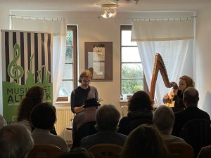 View of author Wolf Stein and Eva Curth with her Celtic harp